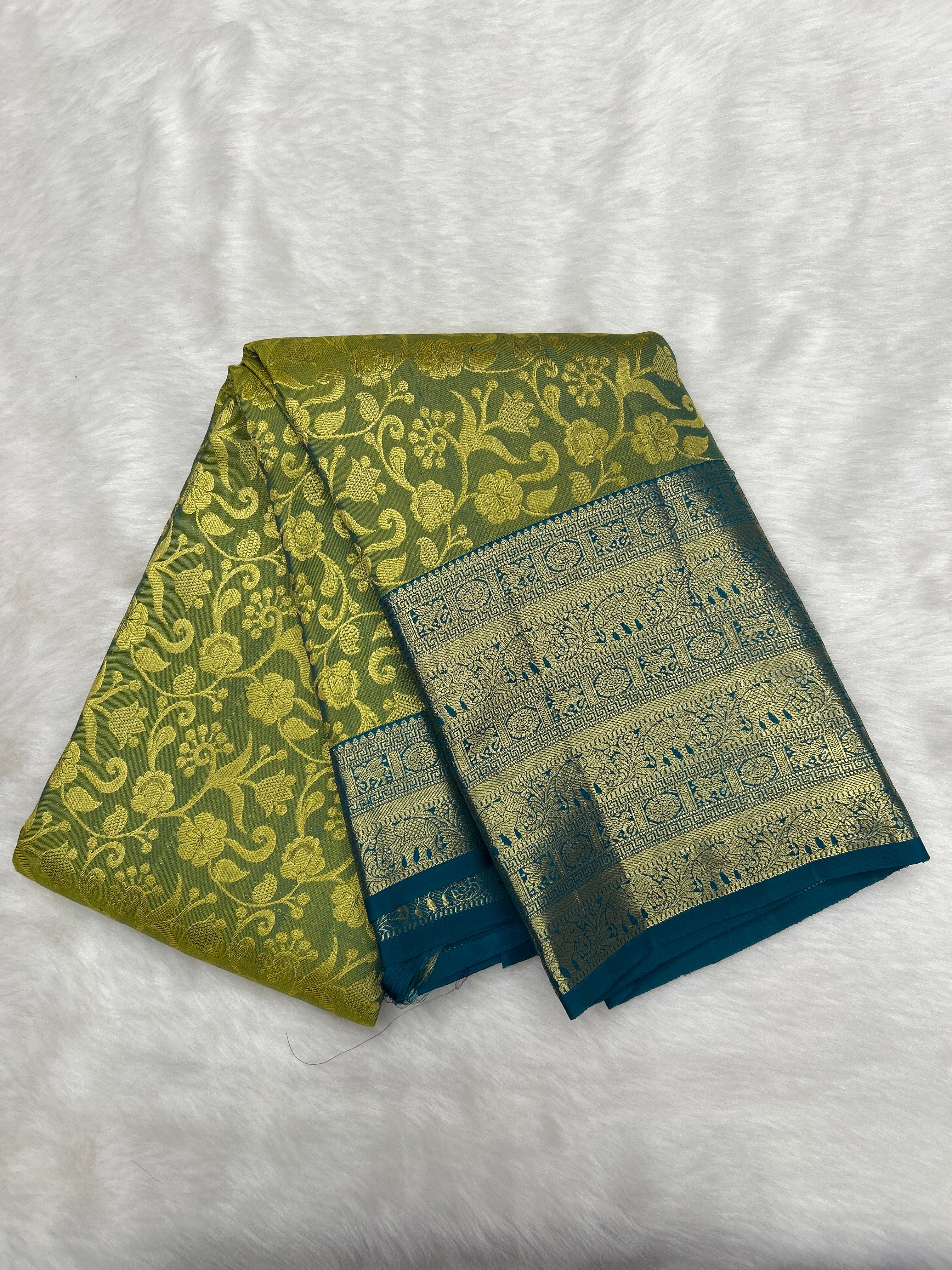Olive green Brocade Kanjeevaram Silk Saree with a rich Teal border